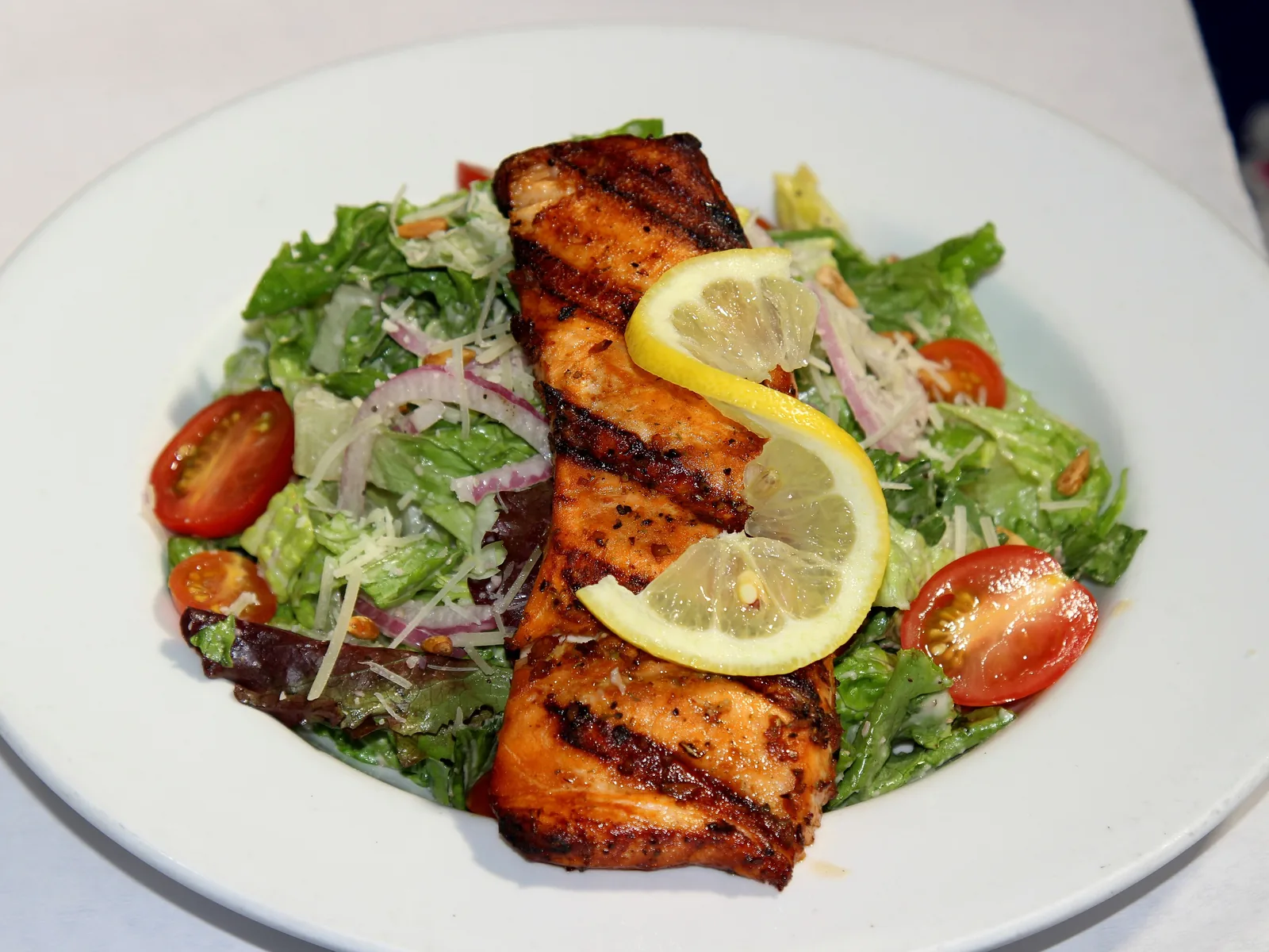 Grilled salmon on Caesar salad
