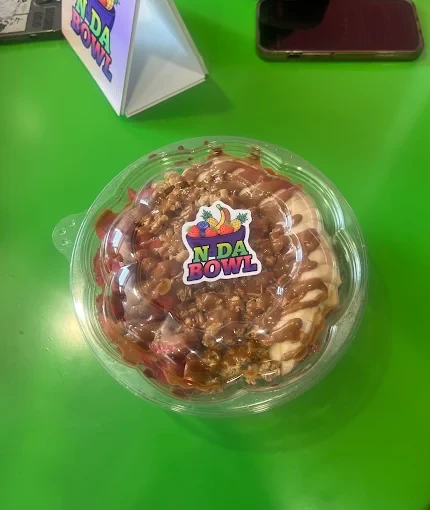 A to-go N Da Bowl with granola and drizzle, sealed with the logo sticker